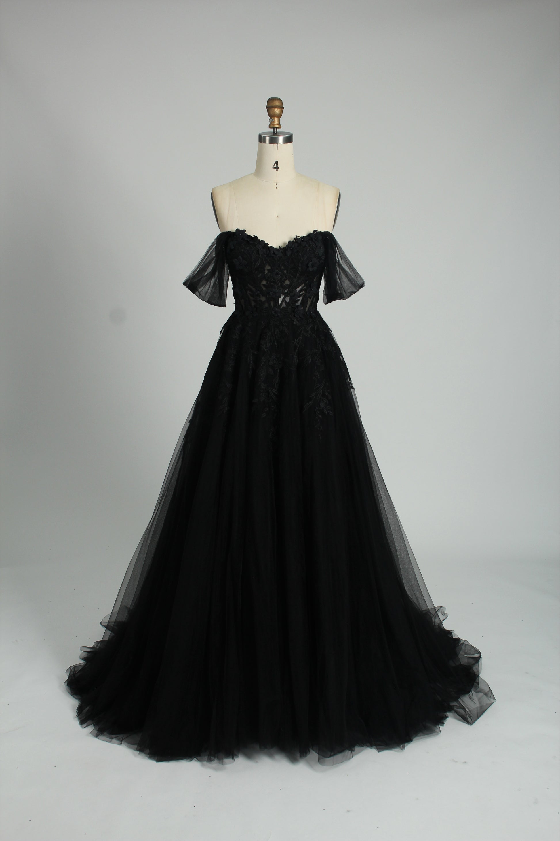 photograph of beautiful woman, elegant off-shoulder green gown, intricate lace details, long flowing tulle skirt, dark curly hair, red lipstick, hands on hips, neutral background, soft lighting, full body shot, fashion photography, classic style, sophisticated, glamorous, high-end fashion, detailed embroidery, smooth fabric texture, poised stance, serene expression, elegant atmosphere.32485c-1b-10