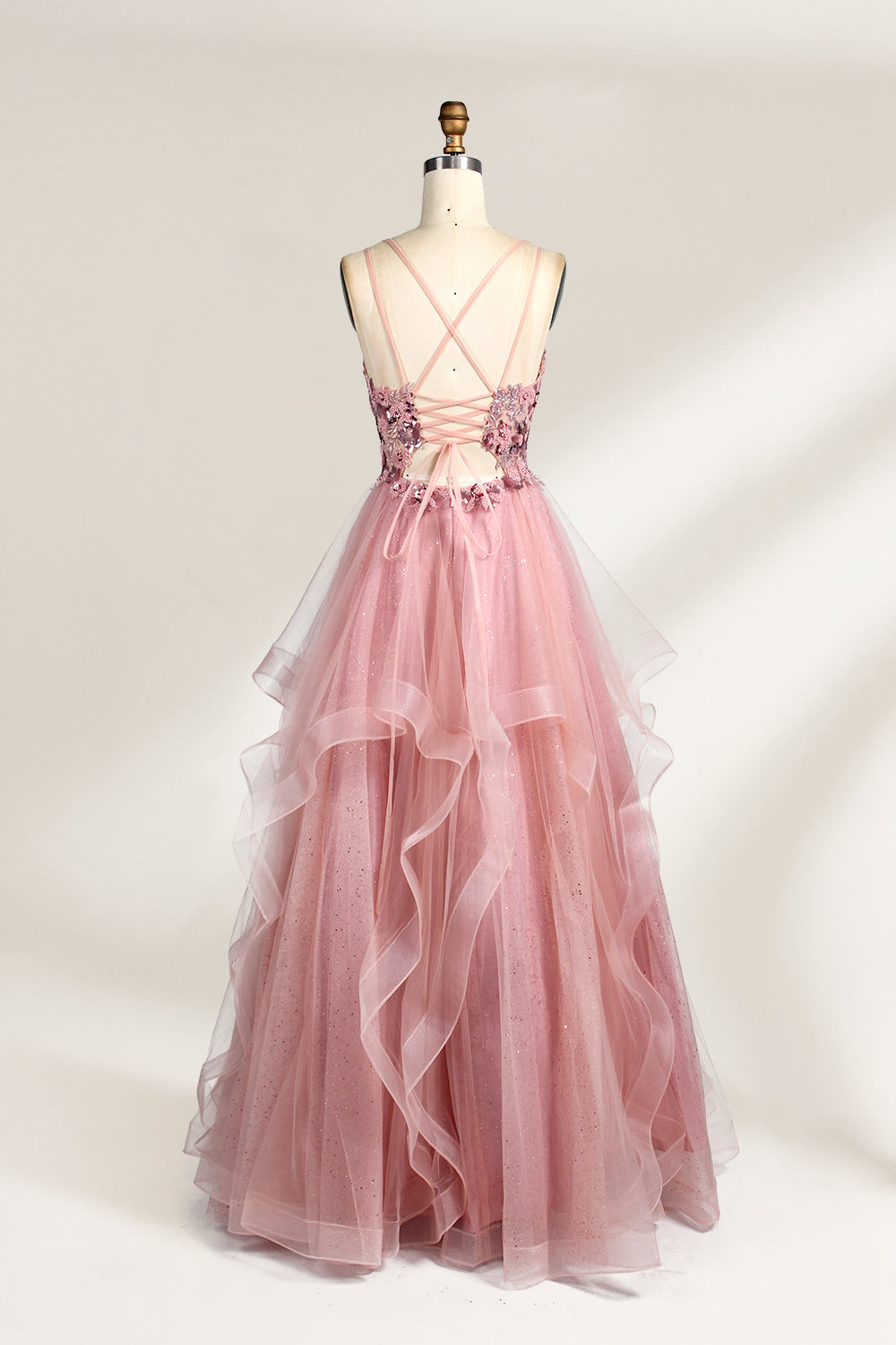 A mannequin displays a pink tulle gown. It features thin straps, a sweetheart neckline, intricate floral appliqués with sequins on the bodice, and a multi - layered, ruffled tulle skirt. The elegant design creates a romantic and glamorous look, perfect for formal events like proms or weddings.2