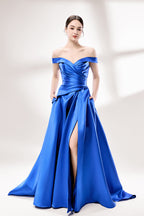 Set against a light backdrop, a woman dons a royal - blue satin gown with an off - shoulder neckline and a high side slit. It has a ruched bodice and pockets, combining elegance and practicality. The shiny satin fabric creates a glamorous look, ideal for proms or formal evening gatherings.1