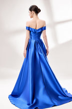 Set against a light backdrop, a woman dons a royal - blue satin gown with an off - shoulder neckline and a high side slit. It has a ruched bodice and pockets, combining elegance and practicality. The shiny satin fabric creates a glamorous look, ideal for proms or formal evening gatherings.2