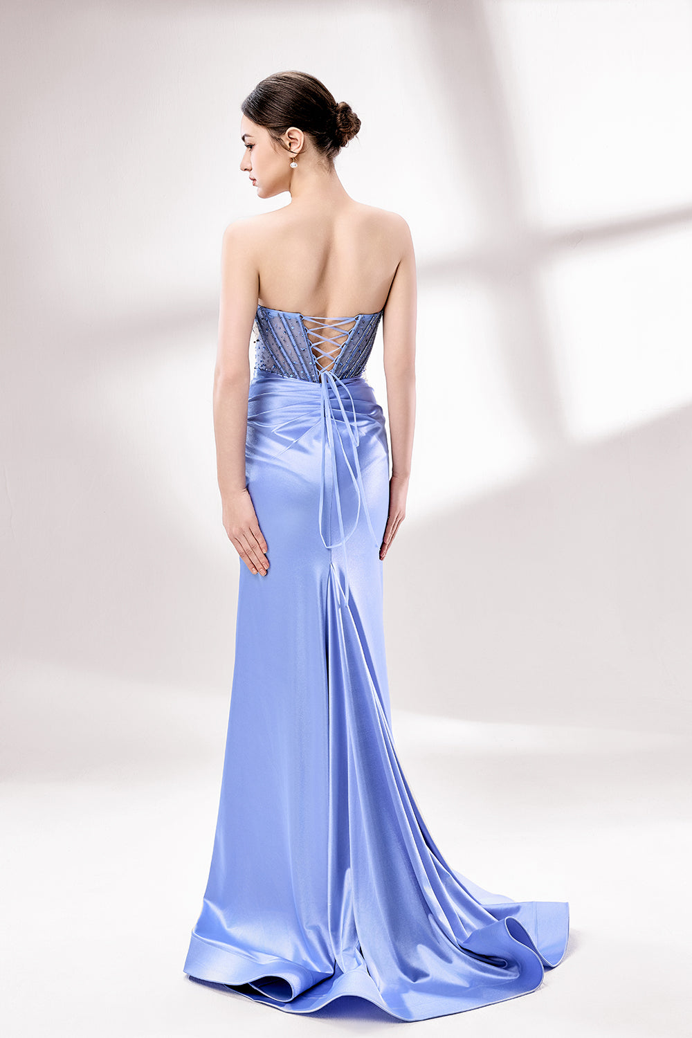 Showcased here is a close - up of a light blue strapless gown. Its bodice is adorned with dense, sparkling blue beads, and the skirt features elegant draping. The intricate design gives off a luxurious and refined vibe, ideal for formal occasions.2