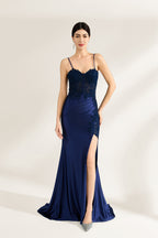 Presented against a light backdrop is a woman donning a navy - blue satin gown. It has thin straps, a sweetheart neckline adorned with lace embroidery, a draped bodice, and a high side slit. The elegant design gives off a glamorous aura, ideal for formal events such as galas or red - carpet affairs.6