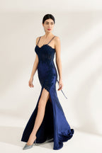 Presented against a light backdrop is a woman donning a navy - blue satin gown. It has thin straps, a sweetheart neckline adorned with lace embroidery, a draped bodice, and a high side slit. The elegant design gives off a glamorous aura, ideal for formal events such as galas or red - carpet affairs.
1