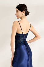 Presented against a light backdrop is a woman donning a navy - blue satin gown. It has thin straps, a sweetheart neckline adorned with lace embroidery, a draped bodice, and a high side slit. The elegant design gives off a glamorous aura, ideal for formal events such as galas or red - carpet affairs.5