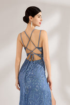 Bathed in soft light, a woman stuns in a blue mermaid - cut gown. It has thin criss - cross straps, a deep V - neckline, and is covered with intricate sequin embroidery, plus a high side slit. The shimmering details lend an air of opulence, perfect for grand galas or red - carpet moments.6