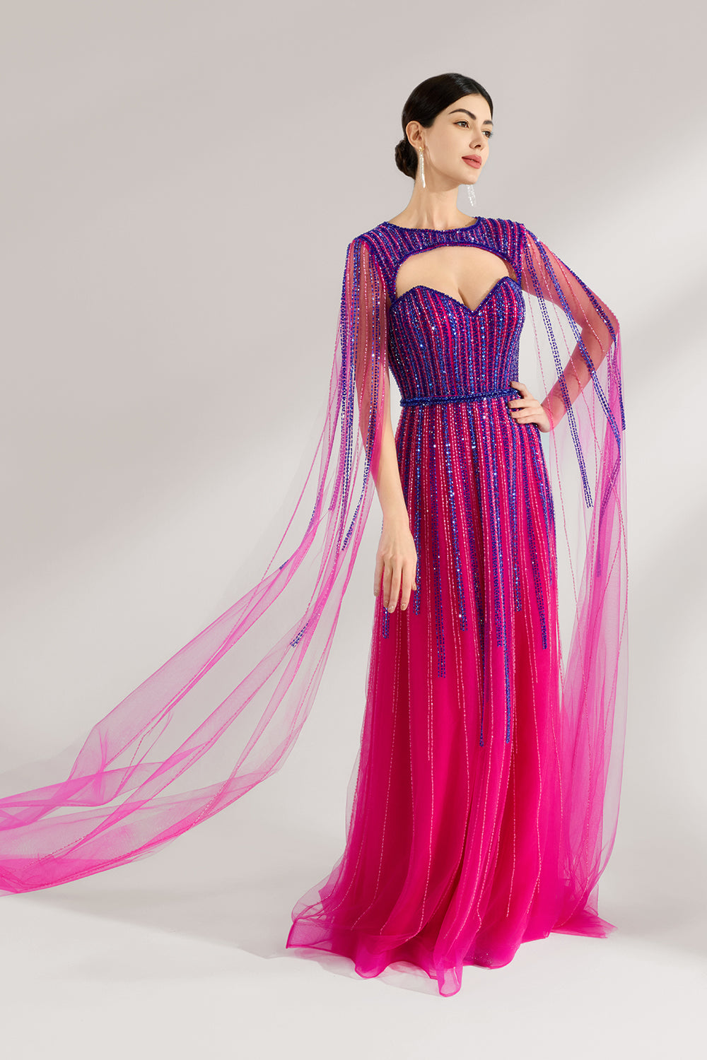 Illuminated softly, a woman enchants in a pink - purple gradient gown. With sequin detailing, a cut - out neckline, and a tulle cape, it creates a magical and elegant look for formal events.1