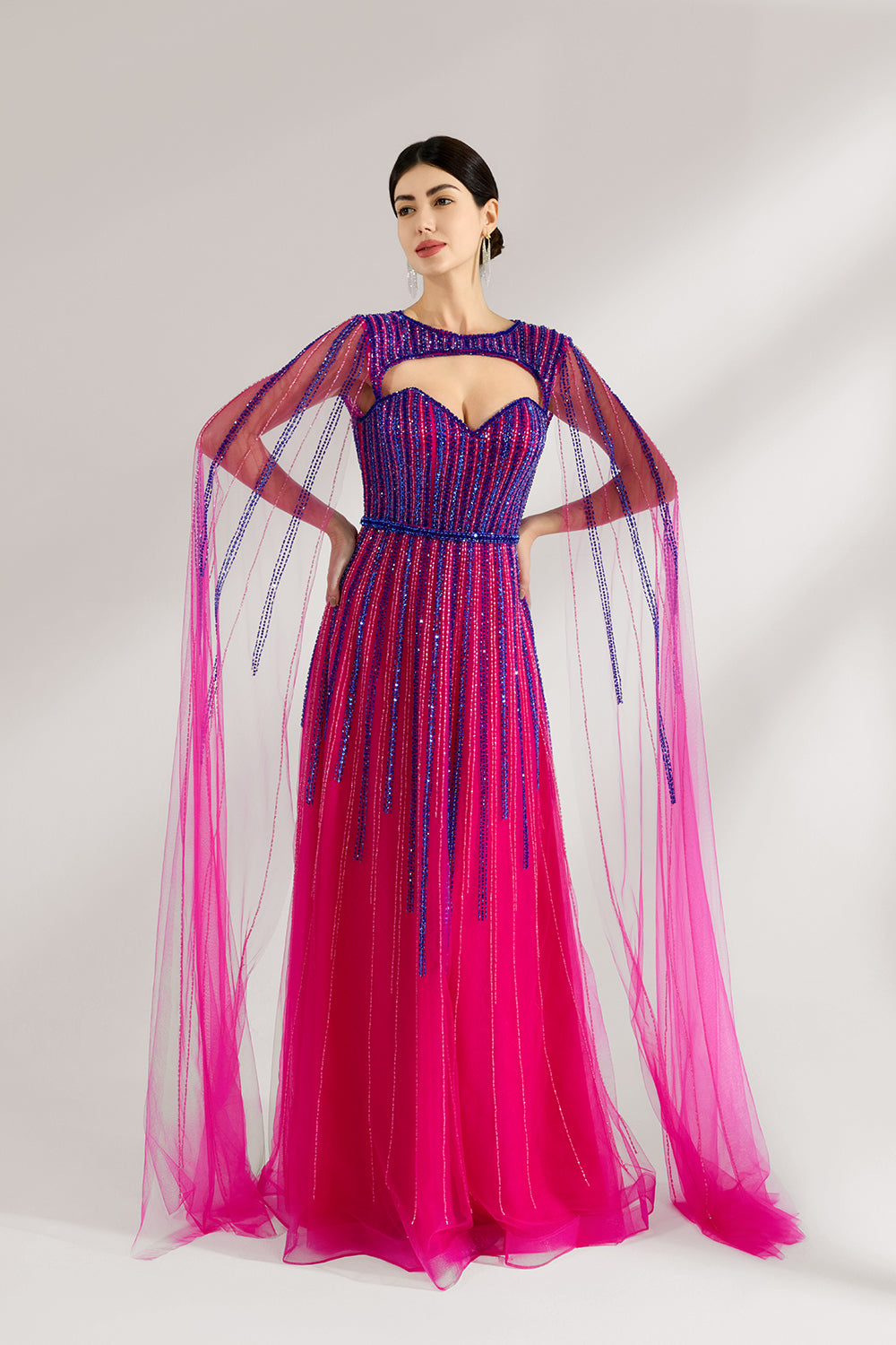 Illuminated softly, a woman enchants in a pink - purple gradient gown. With sequin detailing, a cut - out neckline, and a tulle cape, it creates a magical and elegant look for formal events.4