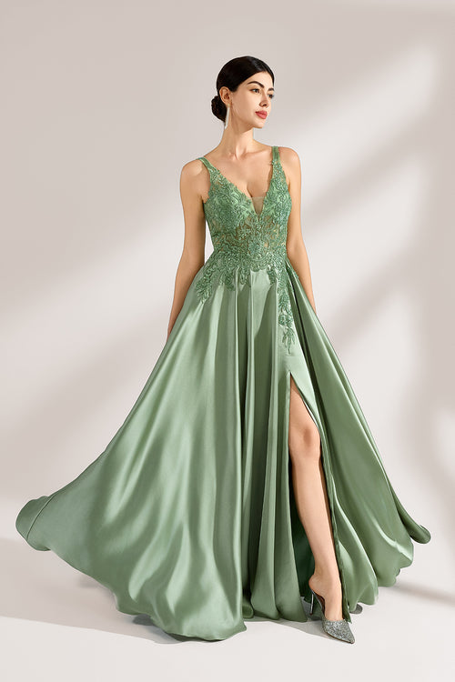 A woman with an elegant updo and a poised stance wears a sage - green satin gown. It has thin straps, a lace - detailed, V - neck bodice, and a high side slit. Paired with silver - tone heels, the outfit radiates grace, perfect for formal events like galas or weddings.3