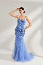 A woman stands against a light background, wearing a light - blue tulle gown. It features thin straps, a deep V - neckline, intricate 3D floral appliqués with sequins on the bodice and skirt, and a mermaid silhouette with a trailing tulle skirt. The elegant design creates a romantic and glamorous look, perfect for formal events like proms or weddings.4