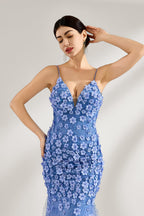 A woman stands against a light background, wearing a light - blue tulle gown. It features thin straps, a deep V - neckline, intricate 3D floral appliqués with sequins on the bodice and skirt, and a mermaid silhouette with a trailing tulle skirt. The elegant design creates a romantic and glamorous look, perfect for formal events like proms or weddings.5