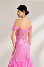 A woman stands against a light background, wearing a pink feather - trimmed gown. It features an off - shoulder neckline, sheer lace panels at the bodice, and a high side slit. The feathered skirt and intricate lace create a glamorous, romantic look, perfect for formal events like galas or weddings, exuding elegance and charm.5