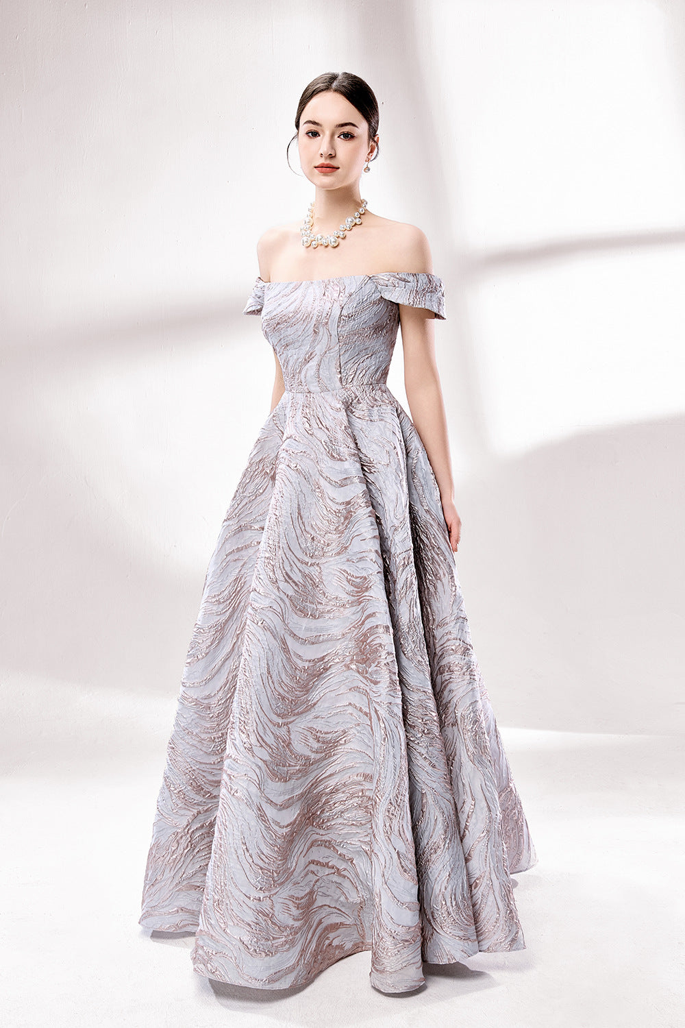 Set against a light backdrop, a woman dons an off - shoulder, light - purple gown with a marble - like pattern. It has short sleeves, a fitted bodice, and a full skirt, along with pockets for practicality. The unique pattern and elegant design make it ideal for formal gatherings, radiating sophistication.4