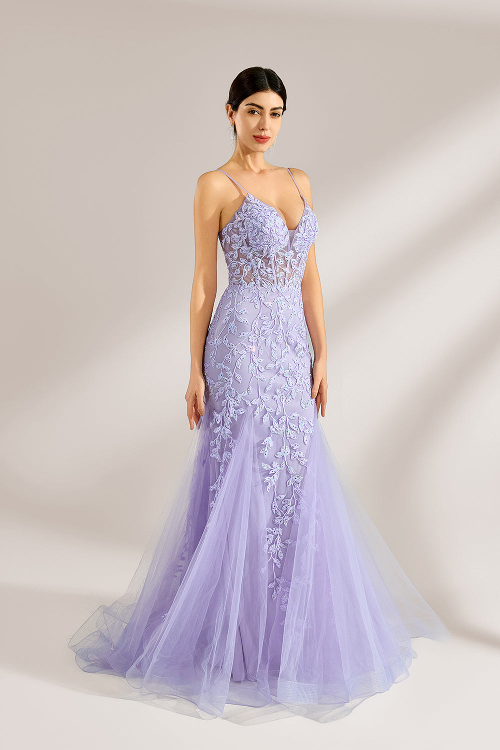 The model sports neatly arranged hair and dangles elegant long earrings. The gown is lavender, featuring a deep V - neckline and slender spaghetti straps. Intricate floral lace embellishes it, and the mermaid - cut skirt, crafted from airy tulle, exudes an elegant and dreamy charm, ideal for formal events.3