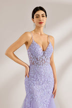 The model sports neatly arranged hair and dangles elegant long earrings. The gown is lavender, featuring a deep V - neckline and slender spaghetti straps. Intricate floral lace embellishes it, and the mermaid - cut skirt, crafted from airy tulle, exudes an elegant and dreamy charm, ideal for formal events.5