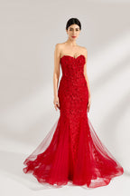 A woman stands against a light background, wearing a red mermaid - style gown. It features a strapless sweetheart neckline, intricate floral lace embroidery throughout, and a flowing tulle skirt with a train. The elegant design creates a glamorous and romantic look, perfect for formal events like proms or weddings.3