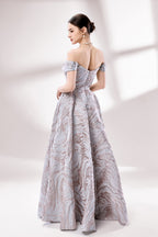 Set against a light backdrop, a woman dons an off - shoulder, light - purple gown with a marble - like pattern. It has short sleeves, a fitted bodice, and a full skirt, along with pockets for practicality. The unique pattern and elegant design make it ideal for formal gatherings, radiating sophistication.2