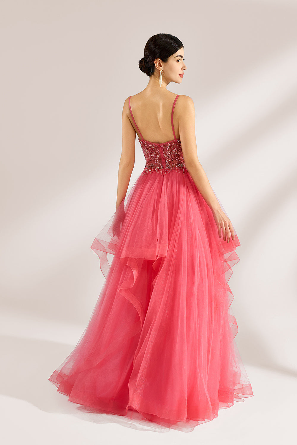 A woman stands against a light background, wearing a coral - pink tulle gown. It features thin straps, a deep V - neckline, and intricate bead embroidery on the bodice. The layered, ruffled tulle skirt creates a romantic and voluminous look, perfect for formal events like proms or weddings.2