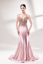 Set against a light backdrop, a woman dons a pink satin gown with a beaded, sheer bodice and a mermaid silhouette. The intricate bead patterns and flowing train add romance, combining sophistication and allure. Ideal for weddings or formal ceremonies, it exudes a regal aura.1