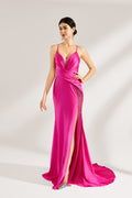 A woman stands against a light background, wearing a hot - pink satin gown. It features thin straps, a deep V - neckline, a draped bodice, a high side slit with crystal embellishments, and a trailing skirt. The elegant design creates a glamorous look, perfect for formal events like galas or red - carpet occasions.1