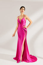 A woman stands against a light background, wearing a hot - pink satin gown. It features thin straps, a deep V - neckline, a draped bodice, a high side slit with crystal embellishments, and a trailing skirt. The elegant design creates a glamorous look, perfect for formal events like galas or red - carpet occasions.3