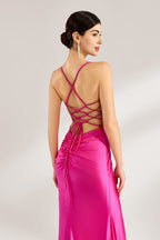A woman stands against a light background, wearing a hot - pink satin gown. It features thin straps, a deep V - neckline, a draped bodice, a high side slit with crystal embellishments, and a trailing skirt. The elegant design creates a glamorous look, perfect for formal events like galas or red - carpet occasions.6