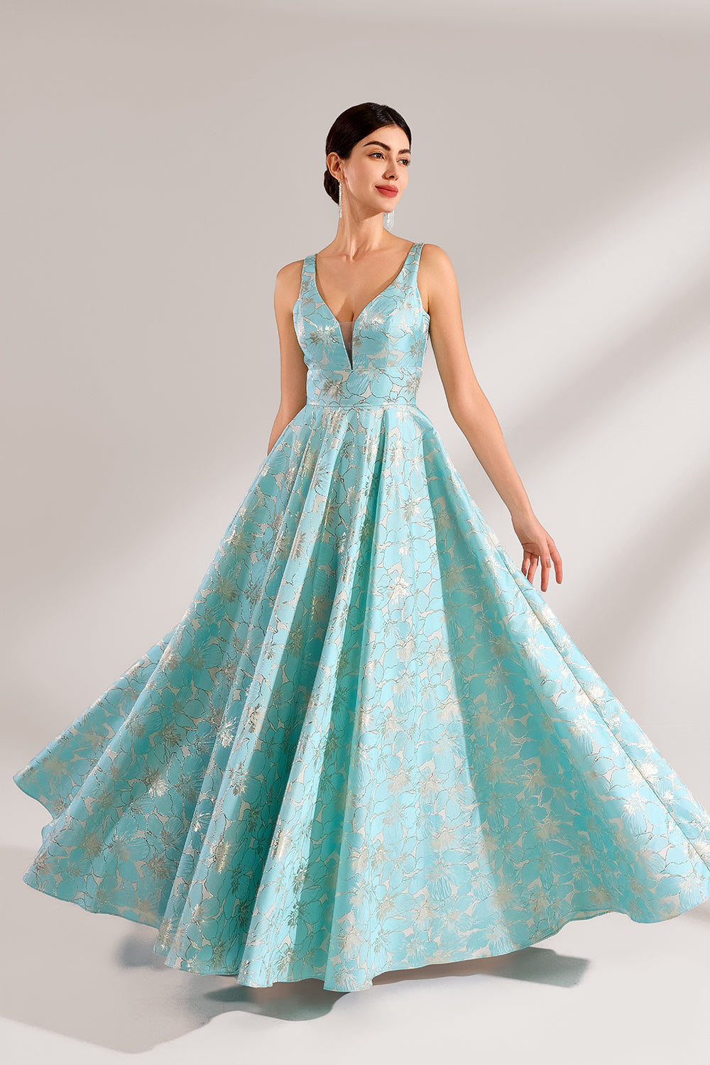 A woman with an elegant updo and a graceful stance wears a light - blue, floral - jacquard gown. It has a deep V - neck, sleeveless design, and a voluminous skirt. Paired with understated heels, the outfit radiates charm, perfect for formal events like galas or weddings.1