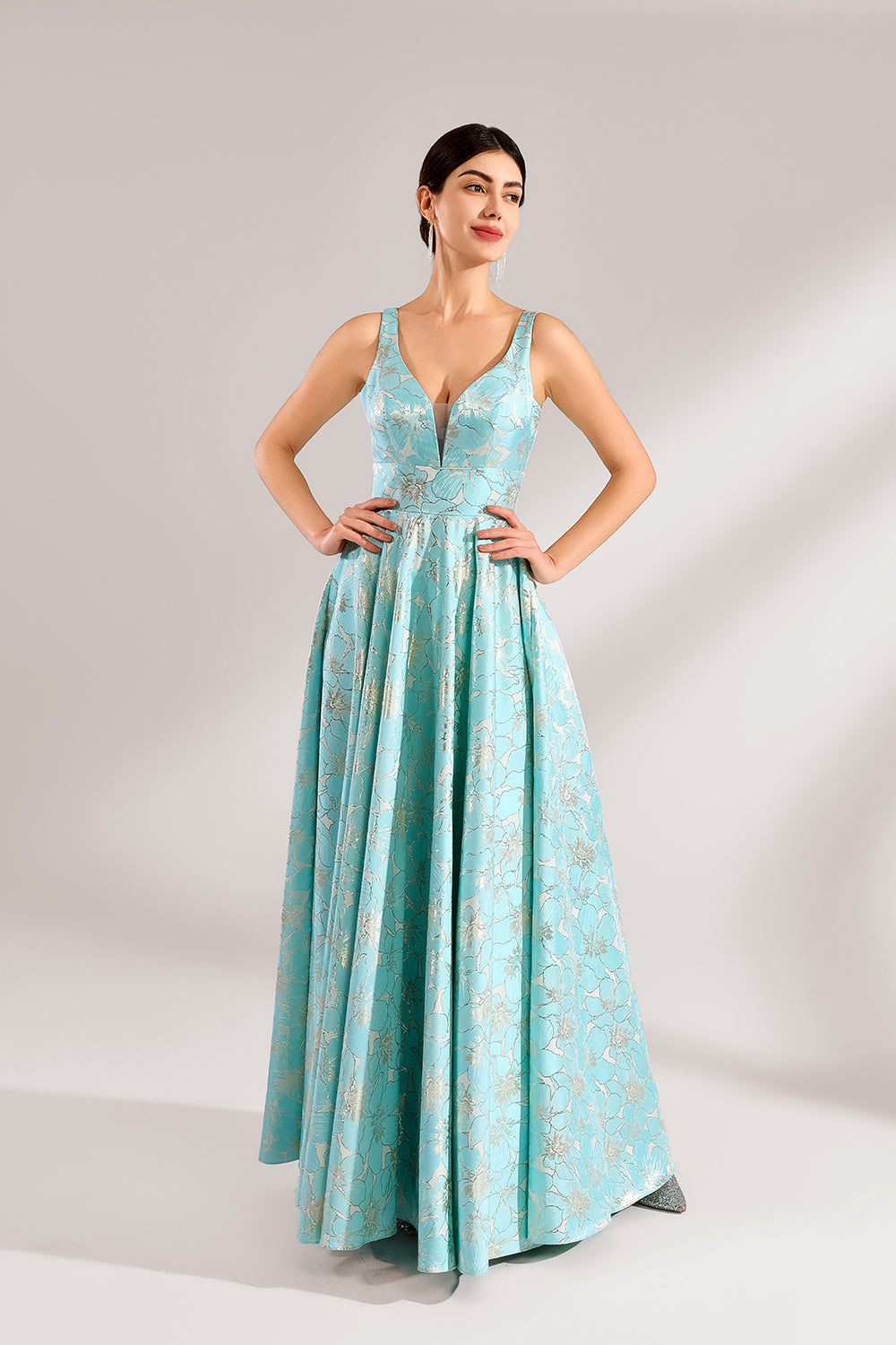 A woman with an elegant updo and a graceful stance wears a light - blue, floral - jacquard gown. It has a deep V - neck, sleeveless design, and a voluminous skirt. Paired with understated heels, the outfit radiates charm, perfect for formal events like galas or weddings.3