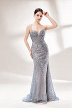 A woman stands against a light - hued background, wearing a light - grey, sheer gown adorned with intricate silver - toned bead patterns. It has thin straps, a deep V - neckline, and a mermaid silhouette. The detailed beadwork and sheer fabric create a glamorous look, perfect for proms or formal parties, radiating sophistication.3