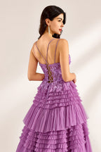 A woman stands against a light background, wearing a lavender tulle gown. It has thin straps, a deep V - neckline, and intricate floral lace embroidery on the bodice. The multi - layered, ruffled tulle skirt with a train creates a romantic and voluminous look, perfect for formal events like weddings or proms, exuding elegance and charm.6
