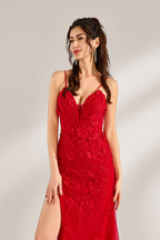 The model has her long hair tied up in a neat style and wears elegant earrings. The dress is a striking red color. It features spaghetti straps, a deep V-neck, and is adorned with delicate floral patterns. There's a high side slit that adds a touch of allure, and the tulle skirt flows gracefully. It's perfect for formal occasions like galas or weddings.5