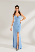 A woman stands against a light background, wearing a light - blue shimmering gown. It features thin straps, a deep V - neckline, a draped bodice, and a high side slit. The elegant design creates a glamorous look, perfect for formal events like galas or red - carpet occasions.
1
