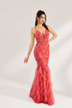 A woman stands against a light background, wearing a coral - pink tulle and lace mermaid gown. It features thin straps, a deep V - neckline with lace - up details, and intricate floral embroidery. The layered, ruffled tulle skirt creates a romantic and glamorous look, perfect for formal events like proms or weddings.4