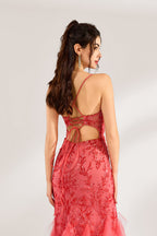A woman stands against a light background, wearing a coral - pink tulle and lace mermaid gown. It features thin straps, a deep V - neckline with lace - up details, and intricate floral embroidery. The layered, ruffled tulle skirt creates a romantic and glamorous look, perfect for formal events like proms or weddings.6