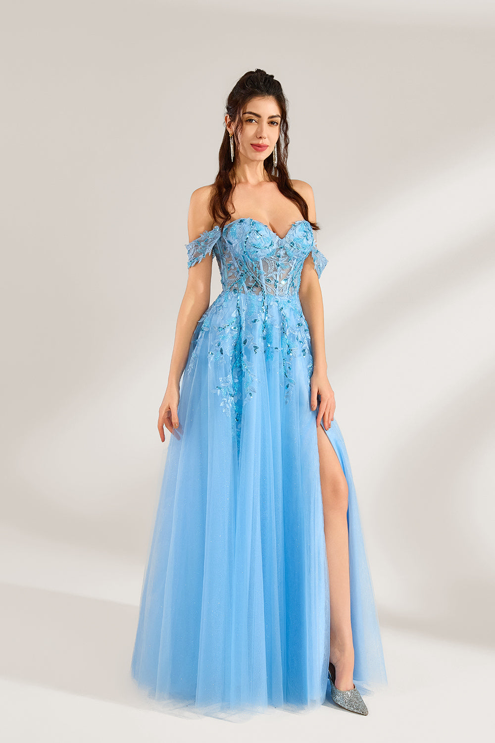 Set against a light backdrop, a woman is clad in a light - blue tulle off - shoulder gown. It boasts a sweetheart neckline, with the bodice embellished by intricate lace embroidery and sequins, and a high side slit. The voluminous tulle skirt, shimmering subtly, lends an elegant and romantic touch, ideal for formal events such as proms or weddings.4