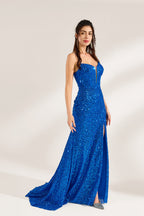 A woman stands against a light background, wearing a royal - blue sequin - covered mermaid gown. It features thin straps, a deep V - neckline with sheer panels, and a high side slit. The sparkling sequins create a glamorous look, perfect for formal events like galas or proms, exuding elegance and charm.5