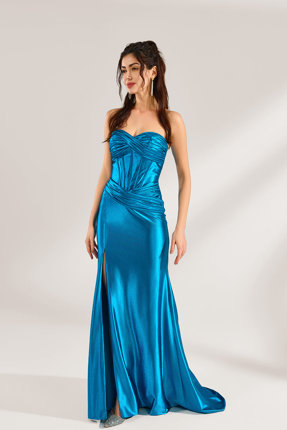 A woman stands against a light background, wearing a turquoise satin strapless gown. It features a draped bodice, a high side slit, and a figure - hugging silhouette. The elegant design creates a glamorous look, perfect for formal events like galas or red - carpet occasions.
4