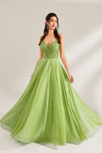 A woman stands against a light background, wearing a lime - green tulle gown. It features thin straps, a deep V - neckline, and intricate lace embroidery on the bodice. The voluminous tulle skirt creates a romantic and elegant look, perfect for formal events like proms or weddings.1