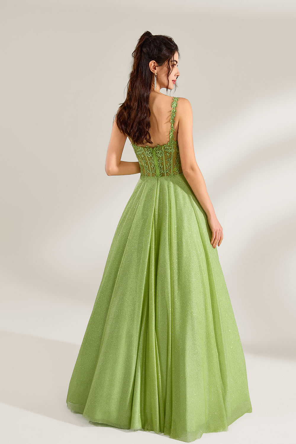 A woman stands against a light background, wearing a lime - green tulle gown. It features thin straps, a deep V - neckline, and intricate lace embroidery on the bodice. The voluminous tulle skirt creates a romantic and elegant look, perfect for formal events like proms or weddings.2