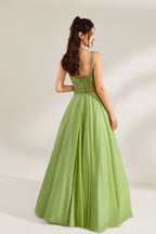 A woman stands against a light background, wearing a lime - green tulle gown. It features thin straps, a deep V - neckline, and intricate lace embroidery on the bodice. The voluminous tulle skirt creates a romantic and elegant look, perfect for formal events like proms or weddings.2