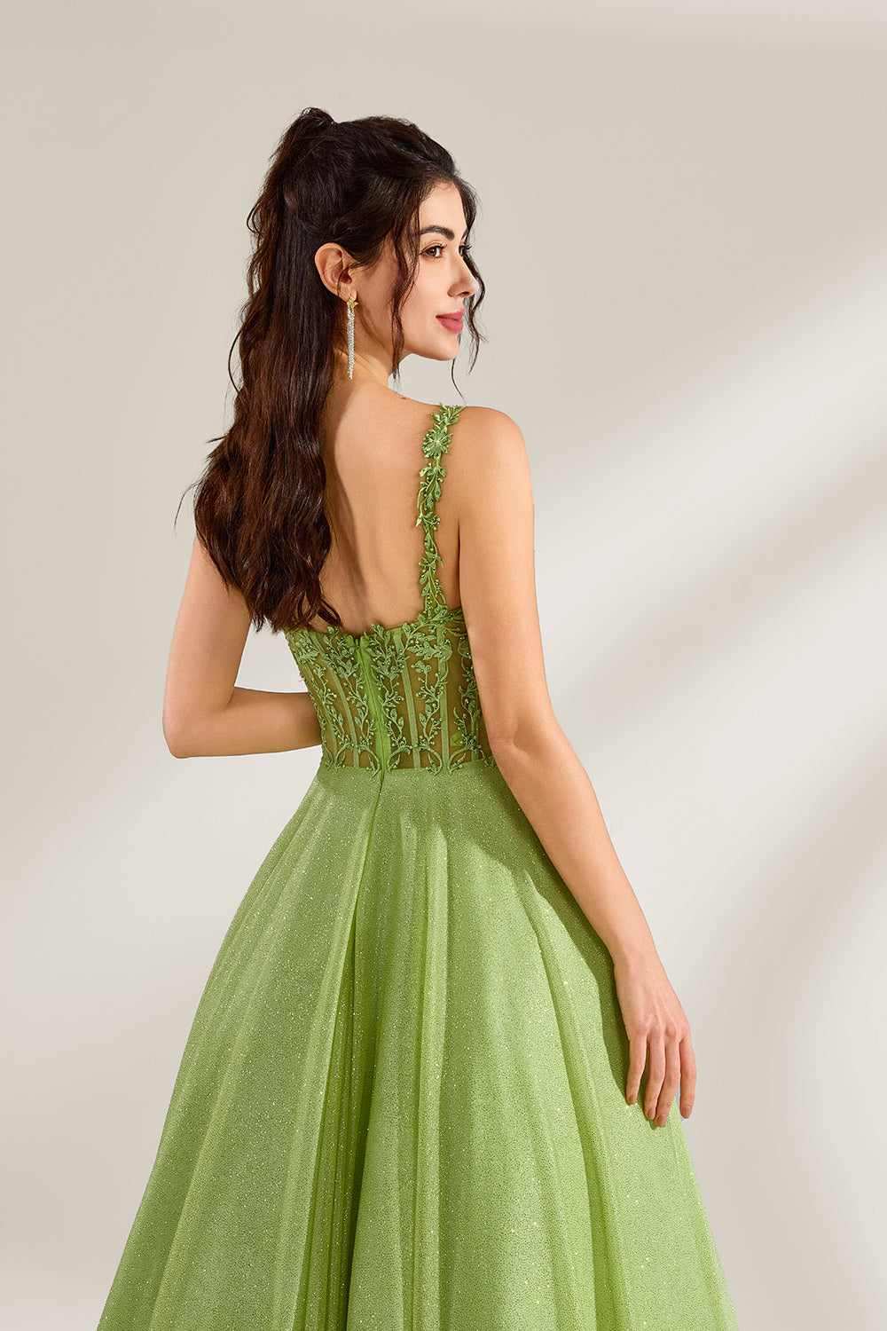 A woman stands against a light background, wearing a lime - green tulle gown. It features thin straps, a deep V - neckline, and intricate lace embroidery on the bodice. The voluminous tulle skirt creates a romantic and elegant look, perfect for formal events like proms or weddings.6