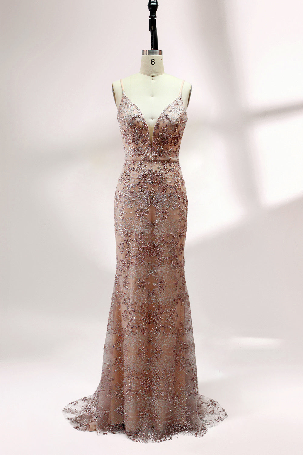 Presented on a mannequin is a blush - hued mermaid - cut gown. It features thin straps, a deep V - neckline, and is adorned with elaborate lace embroidery and sparkling accents. The sophisticated design exudes a glamorous and romantic charm, ideal for formal occasions such as proms or weddings.1
