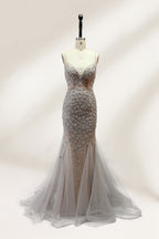 Displayed on a mannequin is a silver - gray mermaid - style gown. It features thin straps, a sweetheart neckline, intricate bead and sequin embroidery throughout, and a flowing tulle skirt. The elegant design creates a glamorous look, perfect for formal events like proms or weddings.1