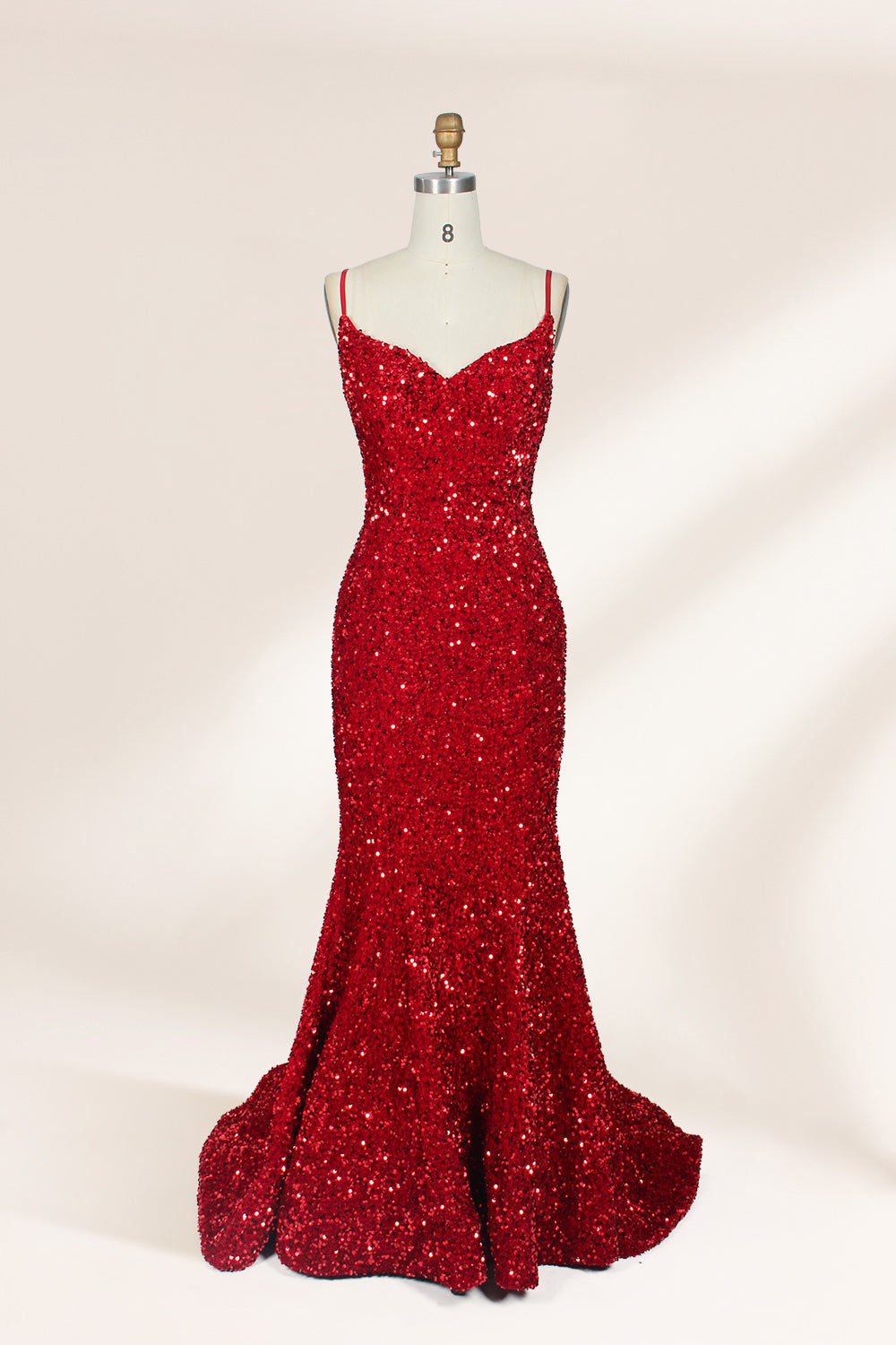 photograph of a mannequin wearing a red sequin evening gown, full-length, floor-length, sleeveless, V-neck, fitted bodice, flared skirt, glossy texture, elegant, glamorous, fashion, studio lighting, white background, soft shadows, high-end fashion, no accessories, no jewelry, no shoes, no face, no hair, no makeup, no background details, simple composition, focus on dress, no people, no textures, no patterns, no objects.01
