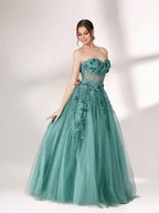 Bathed in soft light, a woman radiates grace in a mint - green evening gown. With floral details, sheer waist, and tulle skirt, it crafts a romantic and elegant look for formal events.1
