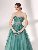 Bathed in soft light, a woman radiates grace in a mint - green evening gown. With floral details, sheer waist, and tulle skirt, it crafts a romantic and elegant look for formal events.34