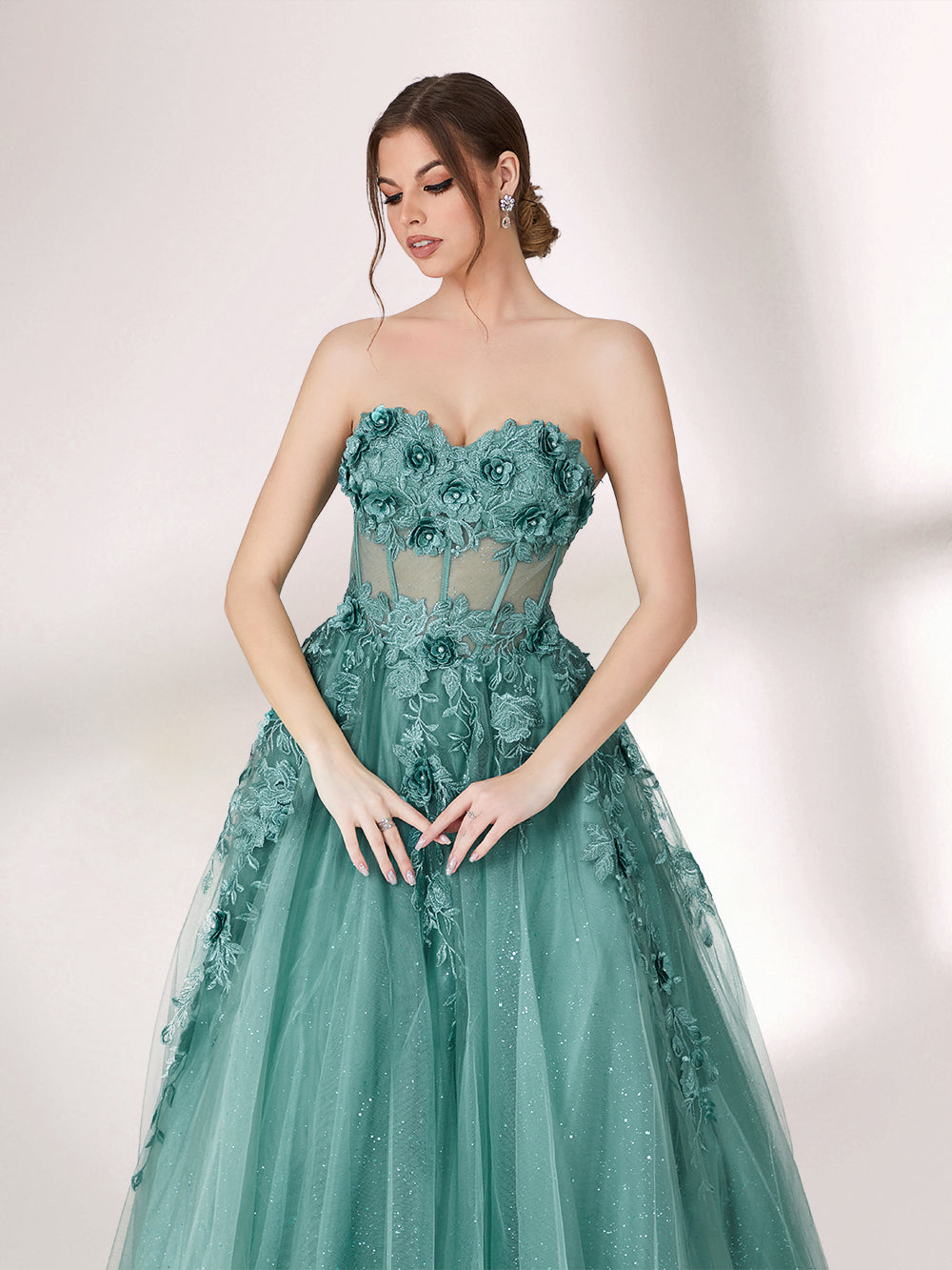 Bathed in soft light, a woman radiates grace in a mint - green evening gown. With floral details, sheer waist, and tulle skirt, it crafts a romantic and elegant look for formal events.34