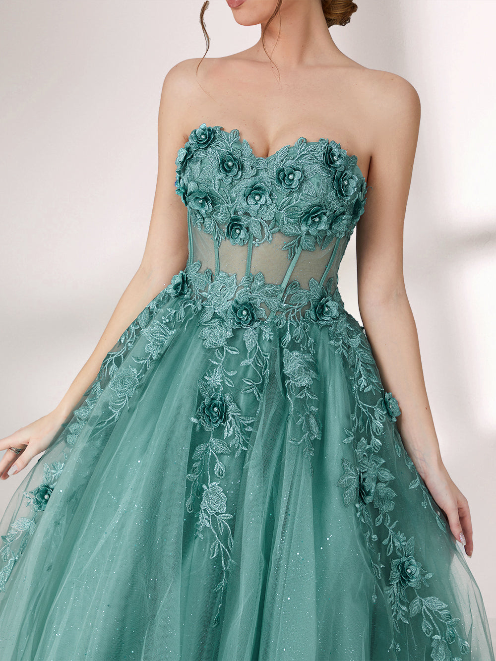 Bathed in soft light, a woman radiates grace in a mint - green evening gown. With floral details, sheer waist, and tulle skirt, it crafts a romantic and elegant look for formal events.6