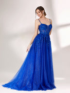 A woman stands against a light background, wearing a bright blue evening gown. It features thin spaghetti straps, a sweetheart neckline with a sheer, sequin - embellished bodice, and a voluminous tulle skirt that shimmers. The elegant design is perfect for formal events.5