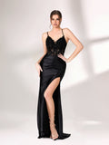 A woman stands against a light background, wearing a black evening gown. It features thin spaghetti straps, a deep V - neckline, intricate black bead and sequin embroidery on a sheer mesh upper, and a sleek satin skirt with a high side slit. The elegant design creates a glamorous and alluring look, perfect for formal events like galas or evening parties.1