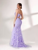 A woman stands against a light background, wearing a lavender mermaid - style evening gown. It has thin spaghetti straps, a sweetheart neckline, and is adorned with delicate white floral embroidery and beadwork throughout. The elegant design is perfect for formal events.4